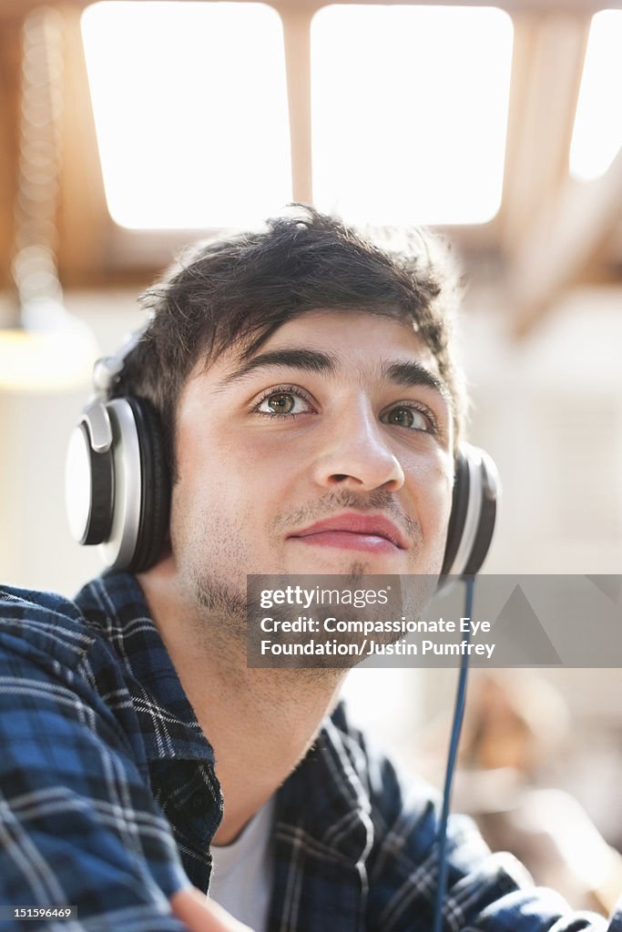 Young man listening to music with headphones