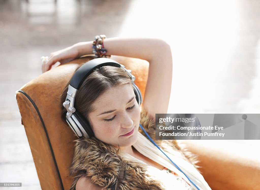 Teenage girl listening to music with headphones