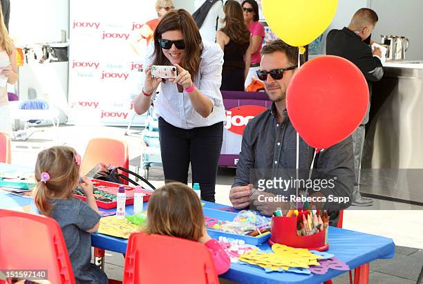 Actress Tiffani Thiessen and husband Brady Smith take a photo of their daughter Harper Renn Smith at the Red CARpet Event Hosted By Britax And Ali...