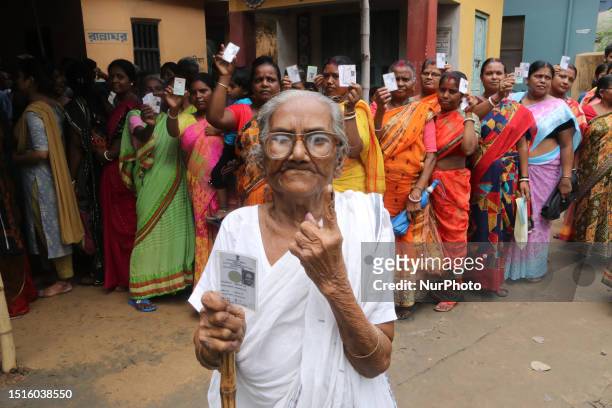 An elderly woman is showing her finger after casting her vote outside a polling station in West Bengal's 'Panchayat' or local elections, on the...