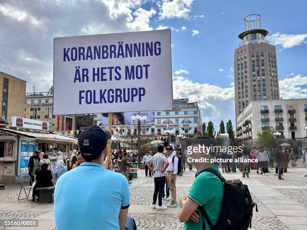 July 2023, Sweden, Stockholm: A man holds up a sign reading "Koranbränning är hets mot folkgrupp" in Medborgarplatsen square near the Stockholm...