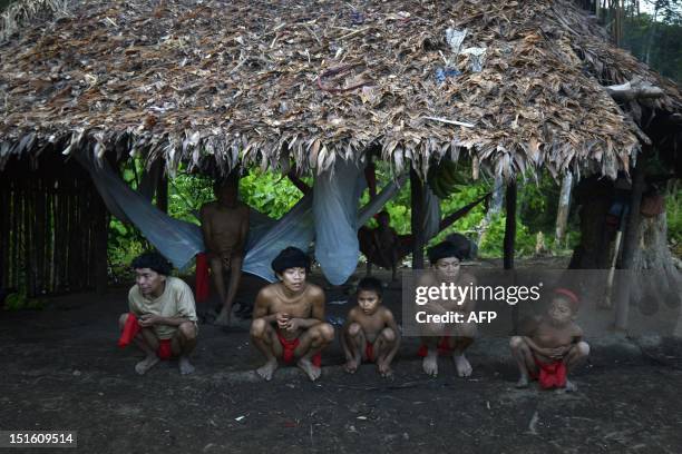 Yanomami natives in a hut at Irotatheri community, in Amazonas state, southern Venezuela, 19 km away from the border with Brazil, on September 7,...