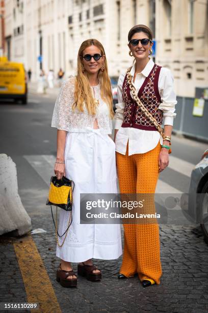 Blanca Miró Scrimieri wears a white lace top, white maxi skirt, Chanel sandals and yellow and black Chanel bag, and Maria de la Orden wears a white...