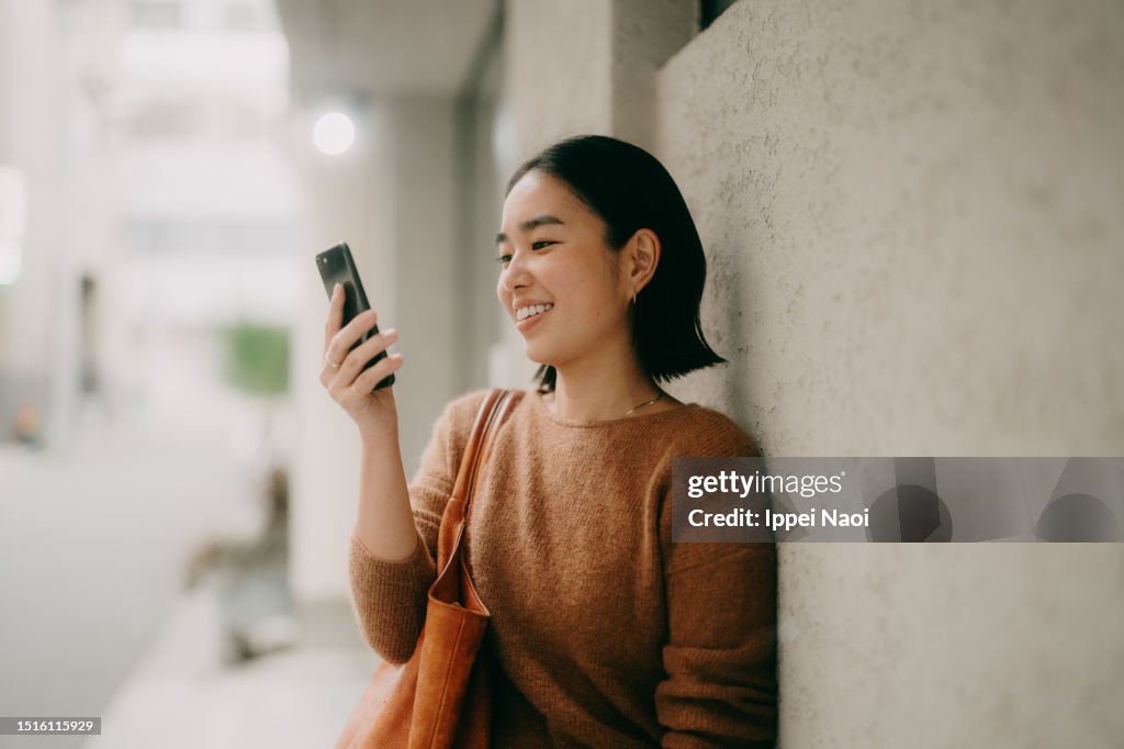Woman on video call using mobile phone on street