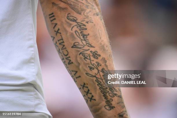 Tattoo reading "Always be a leader, not a follower" is pictured on the arm of Kazakhstan's Alexander Bublik during his men's singles tennis match...