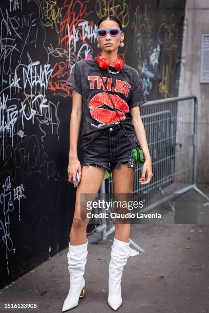 Lineisy Montero wears a grey printed t-shirt, black denim shorts, lilac sunglasses, white boots and green decorated mini bag, outside Alexandre...
