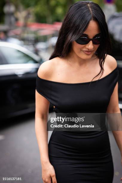 Amina Muaddi wears a black bodycon mini dress and black sunglasses, outside Alexandre Vauthier, during the Haute Couture Fall/Winter 2023/2024 as...