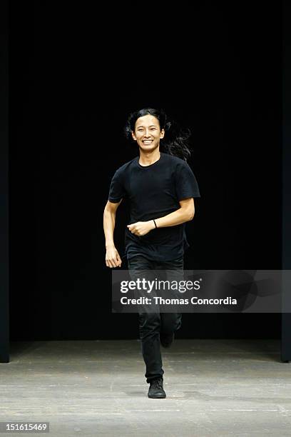 Designer Alexander Wang runs to greet the audience after the Alexander Wang show during Spring 2013 Mercedes-Benz Fashion Week>> at Pier 94 on...