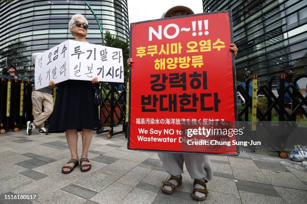 South Korean protesters participate in a rally against the Japanese government's decision to dump radioactive wastewater from the damaged Fukushima...