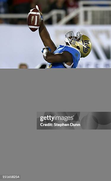 Running back Johnathan Franklin of the UCLA Bruins celebrates after scoring a touchdown on a nine yard pass play in the fourth quarter against the...