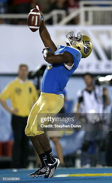 Running back Johnathan Franklin of the UCLA Bruins celebrates after scoring a touchdown on a nine yard pass play in the fourth quarter against the...