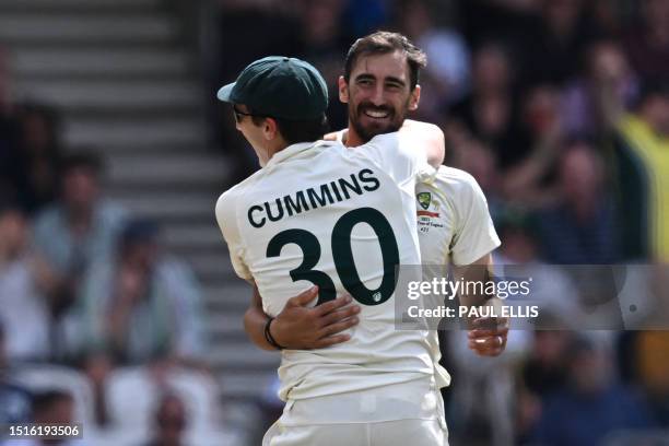 Australia's Mitchell Starc and Australia's Pat Cummins embrace after combining to dismiss England's Harry Brook on day four of the third Ashes...