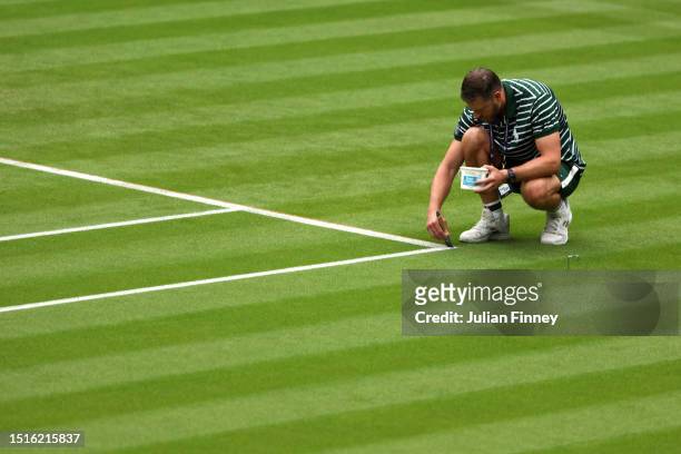 Lines are painted on a court during day three of The Championships Wimbledon 2023 at All England Lawn Tennis and Croquet Club on July 05, 2023 in...