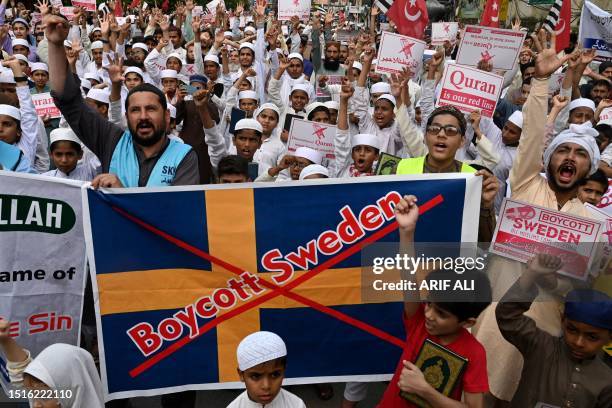 People shout anti-Sweden slogans in Lahore on July 9 as they protest against the burning of the Koran outside a Stockholm mosque that outraged...