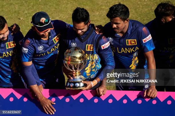Sri Lanka's players pose with the World Cup Trophy after their victory during the ICC Men's Cricket World Cup Qualifier Zimbabwe 2023 Final cricket...