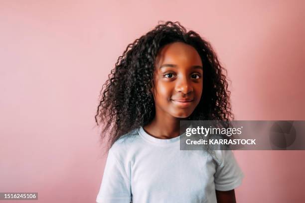 beautiful little afro on pink background. - adolescent africain stock pictures, royalty-free photos & images