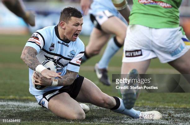Todd Carney of the Sharks goes down in pain during the Second NRL Elimination Final match between the Canberra Raiders and the Cronulla Sharks at...