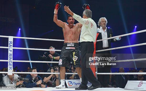 Manuel Charr of Germany reacts after referee Guido Cavalleri of Italy and doctor Stefan Holthusen finished the WBC-heavy weight title fight between...