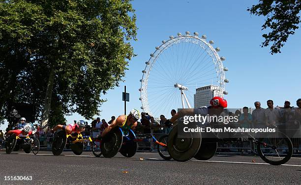 David Weir of Great Britain, Kurt Fearnley of Australia and Marcel Hug of Switzerland compete in the Mens T54 Marathon near the London Eye on day 11...