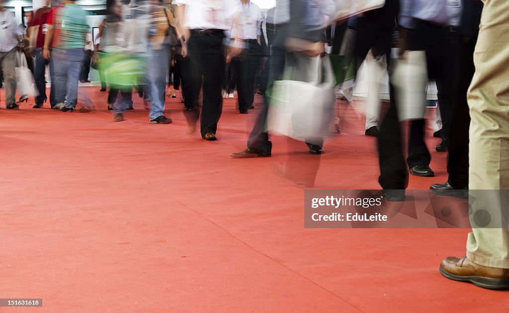 Pedestrians walking on a red carpet