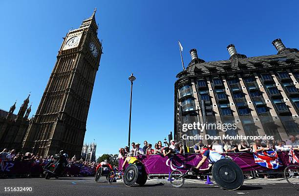 Masazumi Soejima of Japan, Kurt Fearnley of Australia and David Weir of Great Britain, compete in the Mens T54 Marathon near Big Ben on day 11 of the...