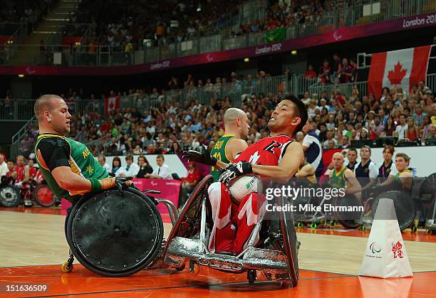 Travis Murao of Canada scores against Ryley Batt of Australia during the Gold Medal match of Mixed Wheelchair Rugby on day 11 of the London 2012...