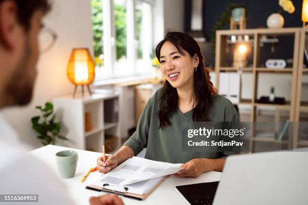female recruiter japanese ethnicity interview male candidate - recruiter stock pictures, royalty-free photos & images