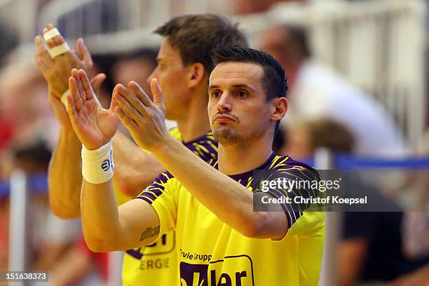 Ivan Nincevic of Berlin applauds Petr Stochl saving a seven meter penalty during the DKB Handball Bundesliga match between TUSEM Essen and Fueches...