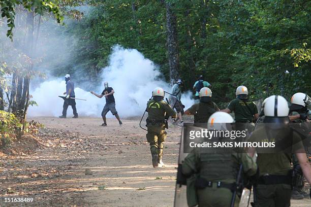 Men clash with riot police in Megali Panagia, Chalkidiki, northern Greece, on 9 September during a protest against efforts by Hellenic Gold, a...