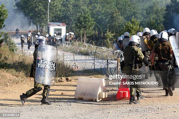 Riot police clash with demonstrators in Megali Panagia, Chalkidiki, northern Greece, on 9 September during a protest against efforts by Hellenic...