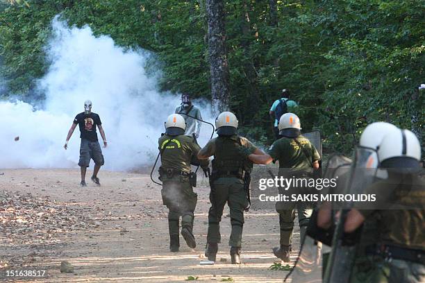 Men clash with riot police in Megali Panagia, Chalkidiki, northern Greece, on 9 September during a protest against efforts by Hellenic Gold, a...