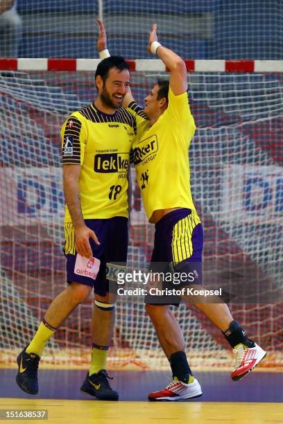 Iker Romero Fernandez and Bartolomiej Jaszka of Berlin celebrate the 31-24 victory after the DKB Handball Bundesliga match between TUSEM Essen and...