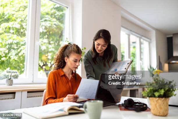 multiracial businesswomen, working together at the modern office - freelance work candid stock pictures, royalty-free photos & images