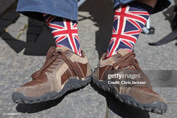 General view of a well wisher wearing Union flag socks ahead of a National Service of Thanksgiving and Dedication To The Coronation Of King Charles...