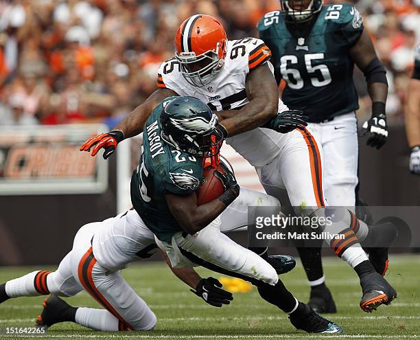 Running back LeSean McCoy of the Philadelphia Eagles is hit by defensive lineman Juqua Parker of the Cleveland Browns during the season opener at...
