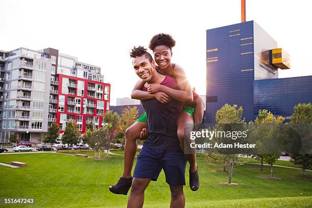 two young friends having fun together outside. - minneapolis park stock pictures, royalty-free photos & images