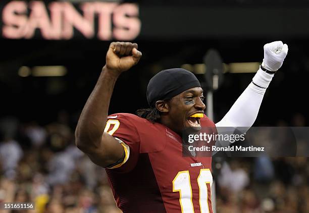 Robert Griffin III of the Washington Redskins celebrates a 40-32 win against the New Orleans Saints during the season opener at Mercedes-Benz...