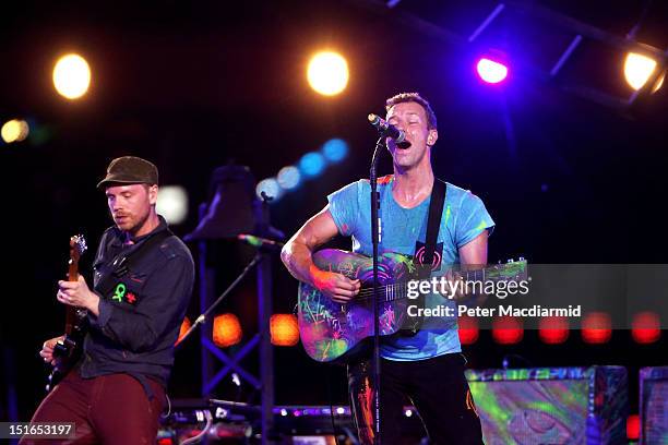 Chris Martin and Will Champion of Coldplay perform during the closing ceremony on day 11 of the London 2012 Paralympic Games at Olympic Stadium on...