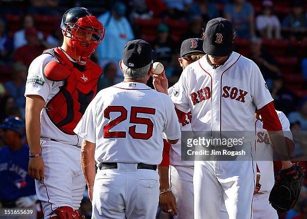 Clay Buchholz of the Boston Red Sox hands the ball over to Bobby Valentine of the Boston Red Sox after the go-ahead run scored in the ninth by the...