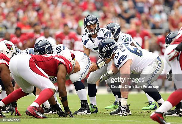 Quarterback Russell Wilson of the Seattle Seahawks prepares to snap the football during the season opener against the Arizona Cardinals at the...