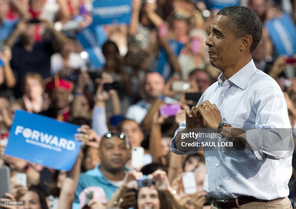 Obama Rasing His Hand US President Barack Obama makes a heart with his hands as he arrives ...