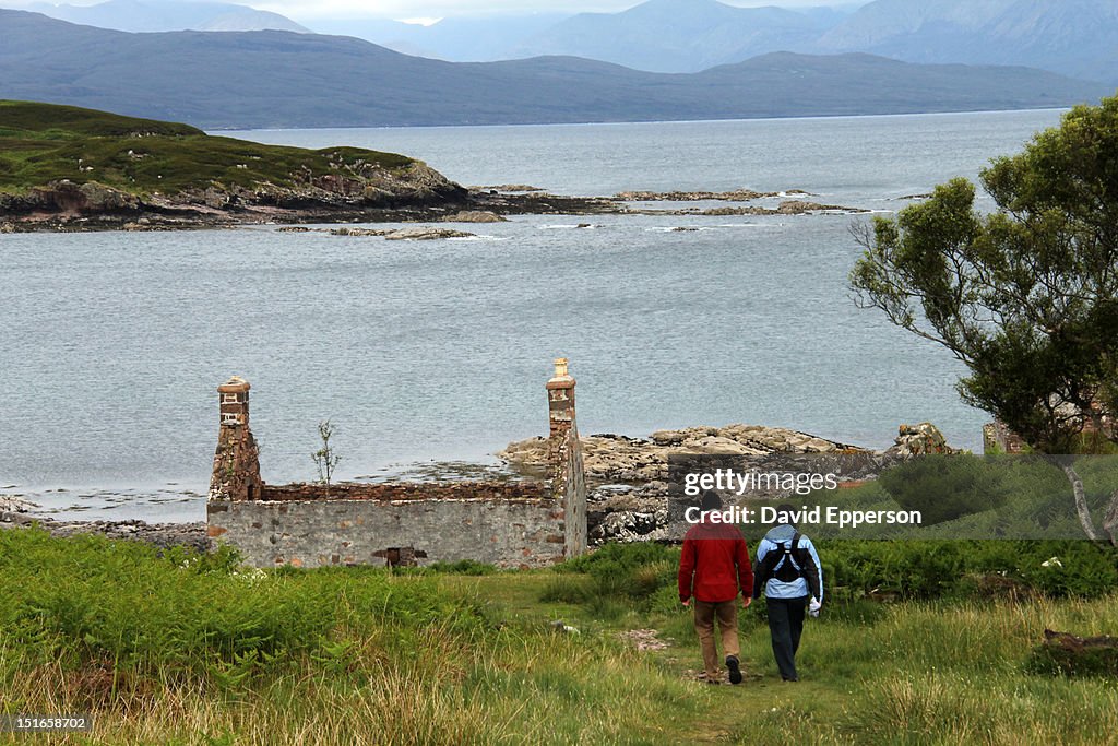 Couple with baby hiking along west Scottish coast