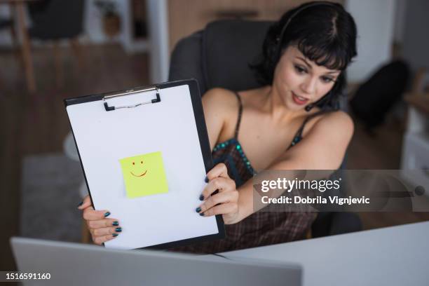 happy young girl demonstrating note pad sticker emotion - girl power stickers stock pictures, royalty-free photos & images