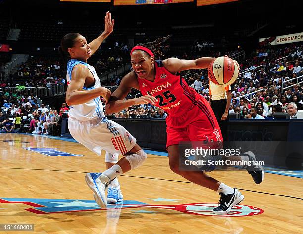Monique Currie of the Washington Mystics drives against Armintie Price of the Atlanta Dream at Philips Arena on September 9, 2012 in Atlanta,...