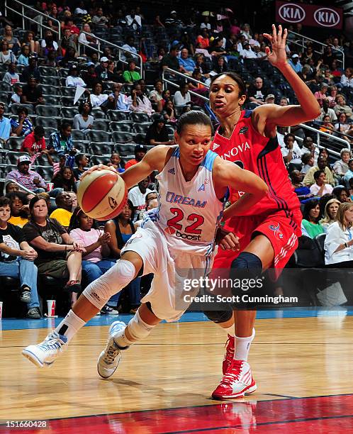 Armintie Price of the Atlanta Dream drives against Iziane Castro Marques # of the Washington Mystics at Philips Arena on September 9, 2012 in...
