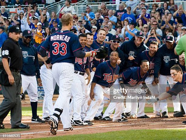 Ben Revere and all the Minnesota Twins celebrate a walk off home run by Justin Morneau of the Minnesota Twins in the ninth inning against the...