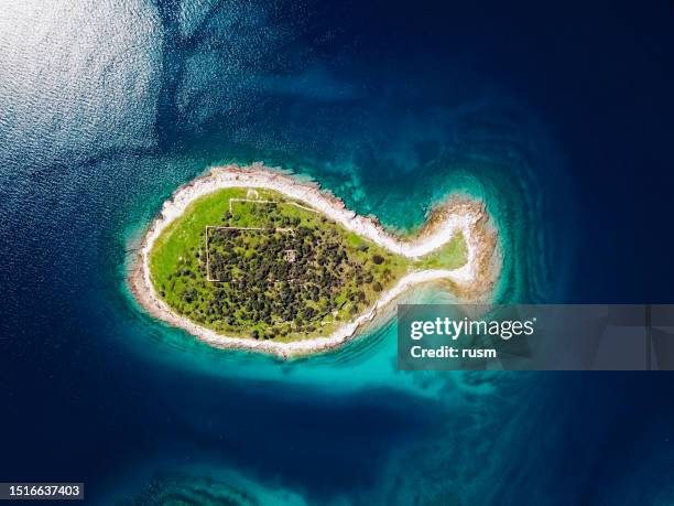 overhead aerial view of fish shaped island gaz in brijuni islands, istria, croatia. - brijuni stock pictures, royalty-free photos & images