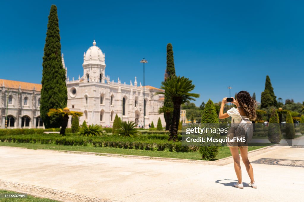 Girl taking photo of Jeronimos Monastery, Lisbon