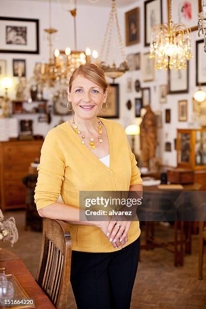 small business owner in her antique shop - antique shop stock pictures, royalty-free photos & images