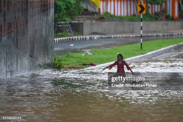 Commuters moves from heavily water logged Bhairav Marg underpass after monsoon rains on July 9, 2023 in New Delhi, India. Delhi-NCR was drenched with...